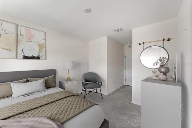 a bedroom with bed and wooden floor