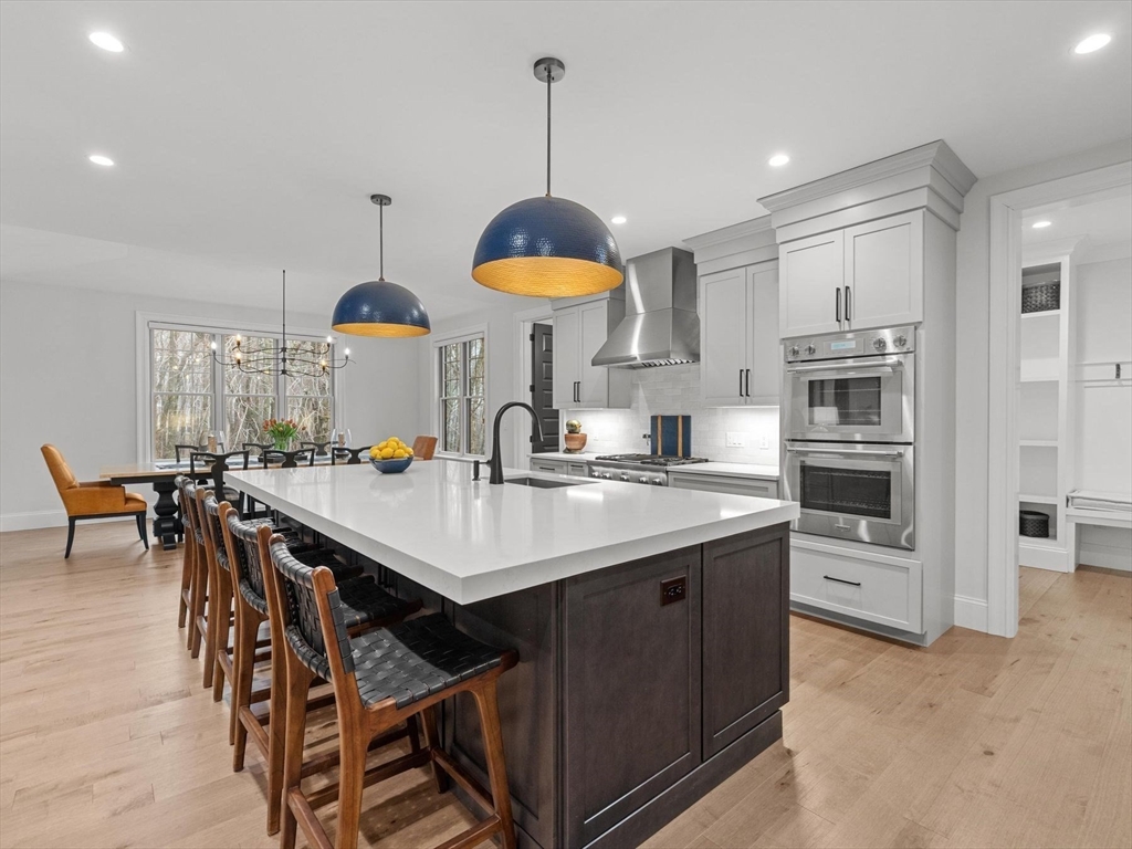 15 Quick Farm Road Westborough, MA 01581 - Photo 15 of 40 a kitchen with stainless steel appliances a sink a stove a refrigerator cabinets and chairs