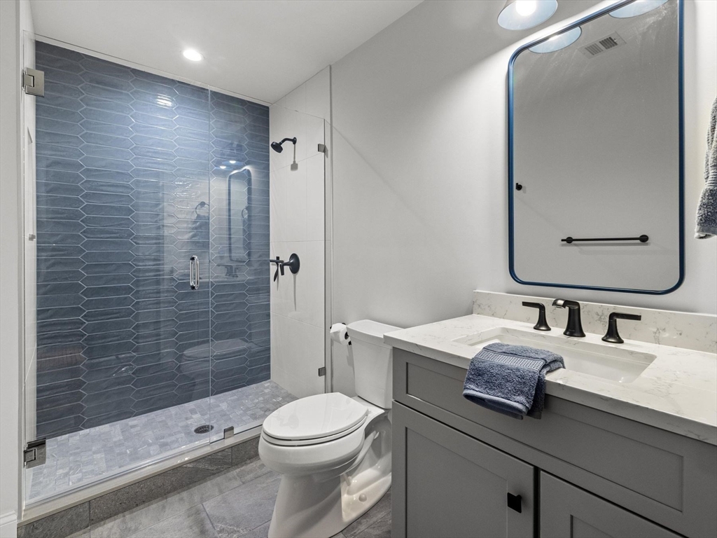 15 Quick Farm Road Westborough, MA 01581 - Photo 28 of 40 a bathroom with a double vanity sink toilet and shower