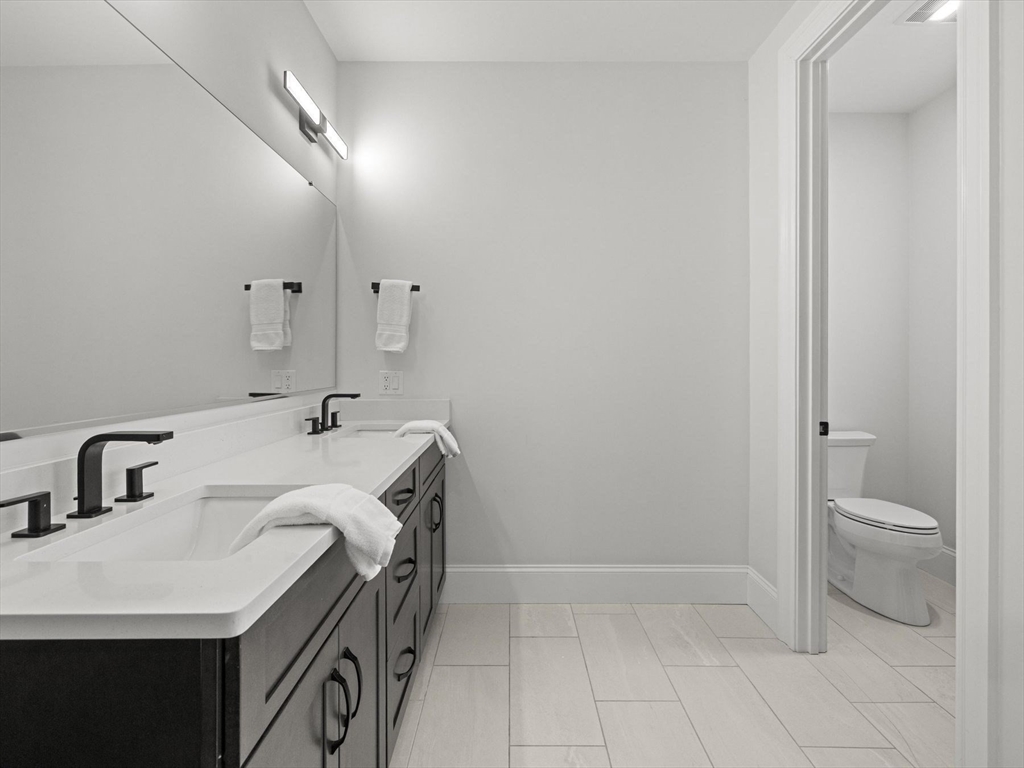 15 Quick Farm Road Westborough, MA 01581 - Photo 9 of 40 a bathroom with a sink a toilet and a mirror