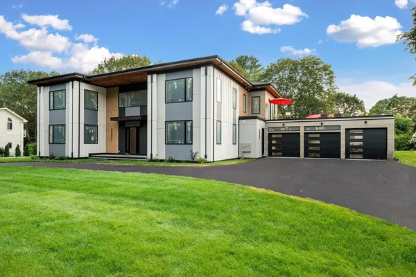 a view of a house with a yard and garage