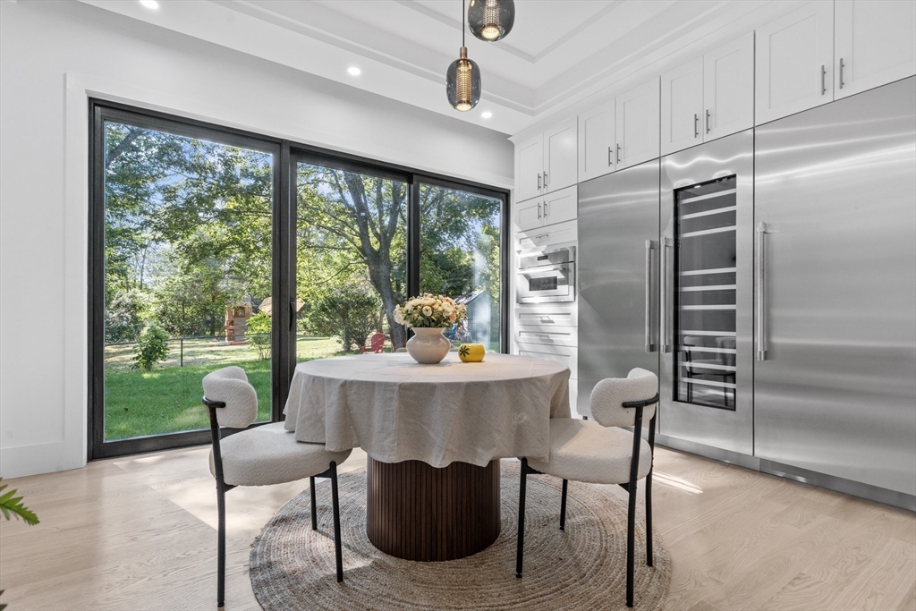 197 Woburn Street Lexington, MA 02420 - Photo 11 of 42 a dining room with furniture a chandelier and a floor to ceiling window