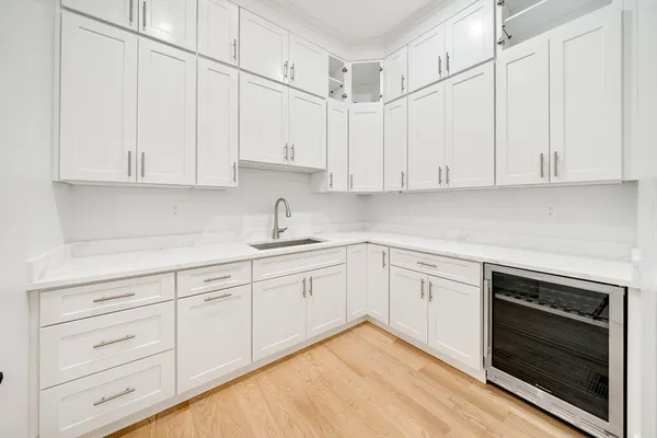 a kitchen with granite countertop white cabinets and stainless steel appliances
