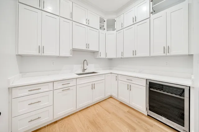 a kitchen with granite countertop white cabinets and stainless steel appliances