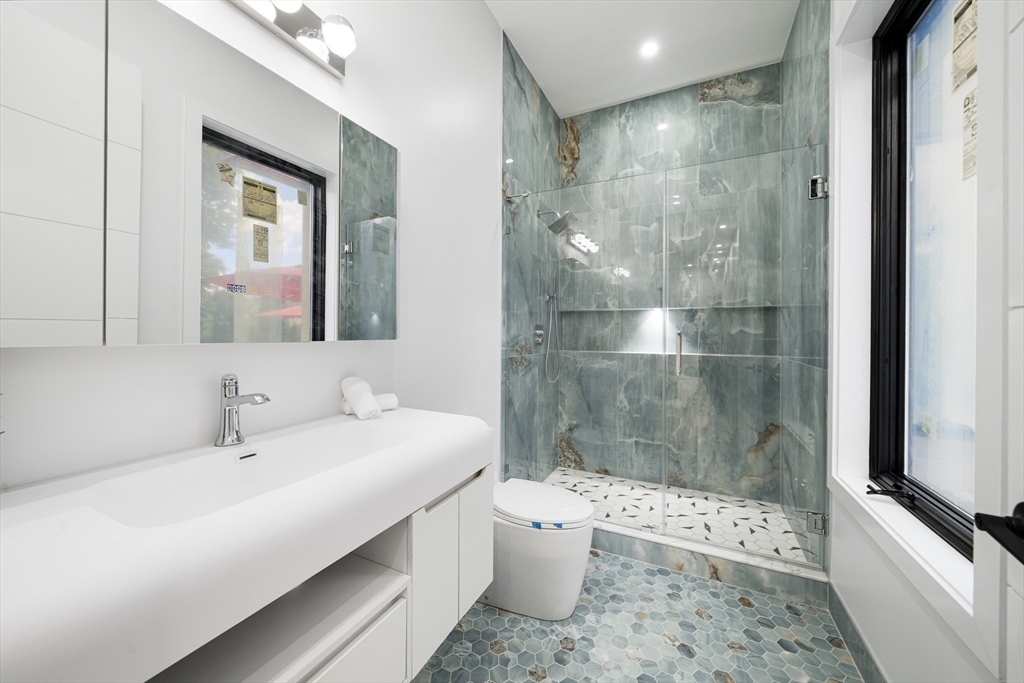 197 Woburn Street Lexington, MA 02420 - Photo 19 of 42 a bathroom with a bathtub shower sink mirror and toilet