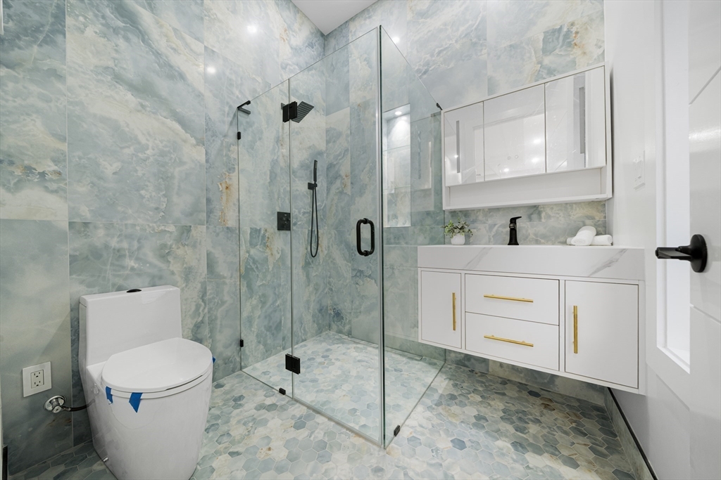 197 Woburn Street Lexington, MA 02420 - Photo 20 of 42 a bathroom with a sink a toilet and shower