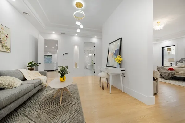 a living room with furniture and a chandelier