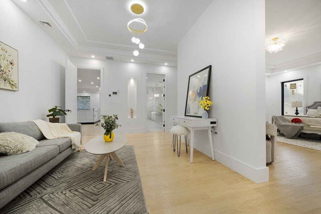 197 Woburn Street Lexington, MA 02420 - Photo 23 of 42 a living room with furniture and a chandelier