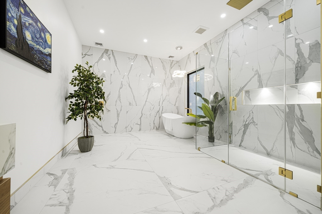 197 Woburn Street Lexington, MA 02420 - Photo 25 of 42 a large white room with a potted plant and a large window