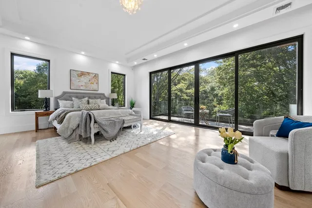 a bedroom with furniture and large windows