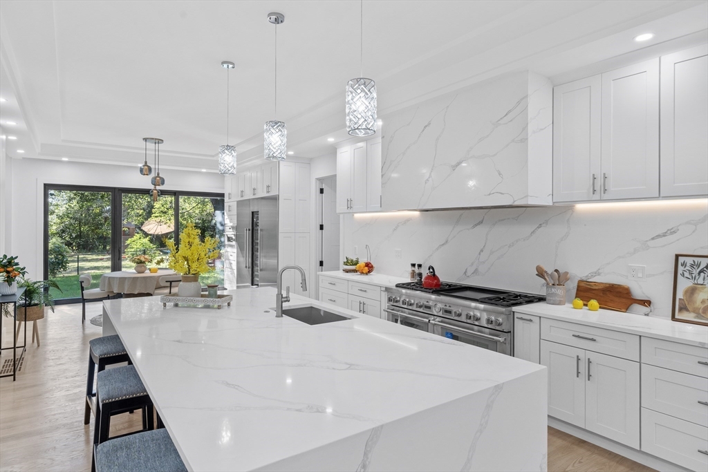 197 Woburn Street Lexington, MA 02420 - Photo 36 of 42 a kitchen with a sink a stove and white cabinets