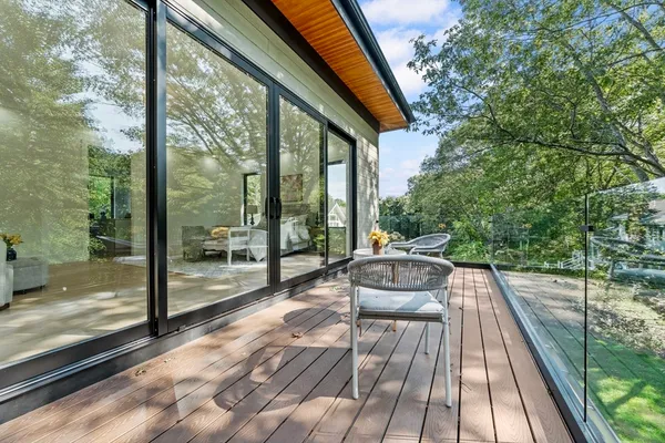a view of balcony with chairs and wooden fence