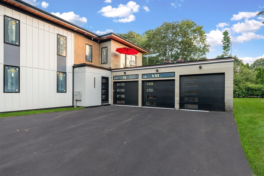 197 Woburn Street Lexington, MA 02420 - Photo 41 of 42 a front view of a house with a yard and garage
