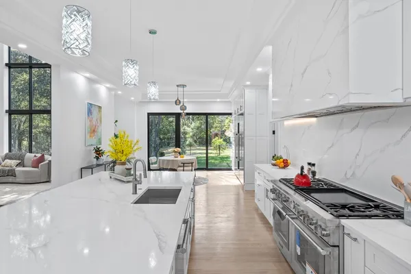 a kitchen with stainless steel appliances granite countertop a stove and cabinets