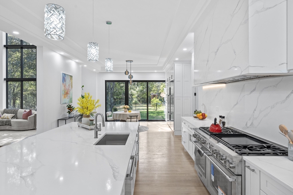 197 Woburn Street Lexington, MA 02420 - Photo 7 of 42 a kitchen with stainless steel appliances granite countertop a stove and cabinets