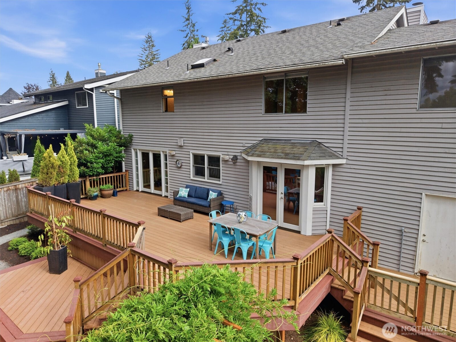 2101 233rd Street Southeast Bothell, WA 98021 - Photo 24 of 40 a view of a patio with couches chairs potted plants and wooden fence