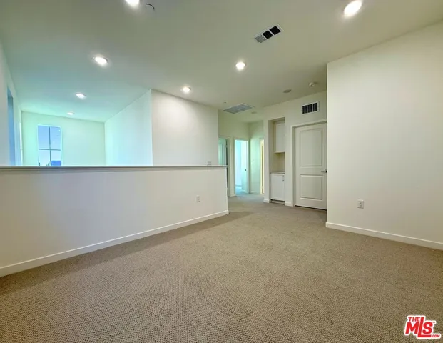 an empty room with a empty space and windows