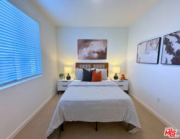 a bedroom with a bed and window