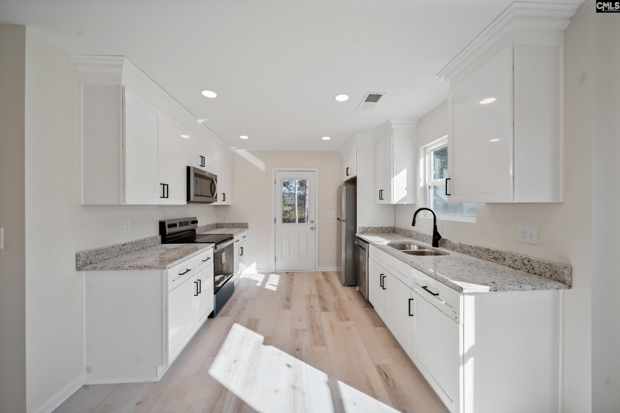 116 Sunny Acres Road Eastover, SC 29044 - Photo 12 of 40 a large kitchen with stainless steel appliances granite countertop a sink a stove and cabinets
