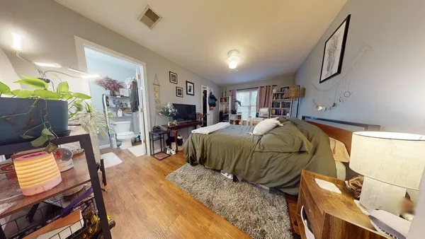 a bed room with a bed furniture and a flat screen tv