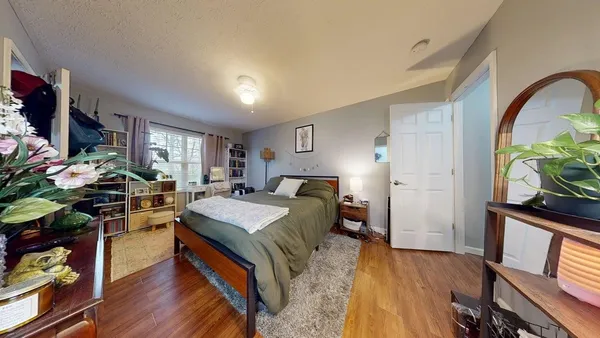 a bed room with wooden floor and furniture