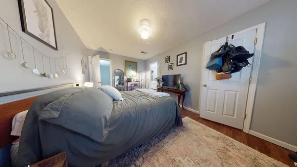 a bed room with a bed and a mirror