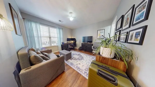 a living room with furniture fireplace and a large window