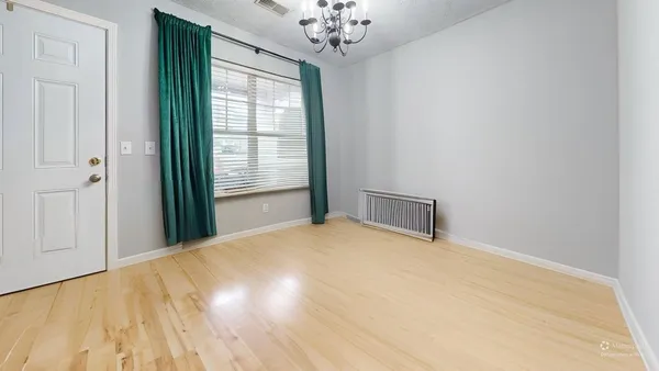 a view of a big room with windows and chandelier