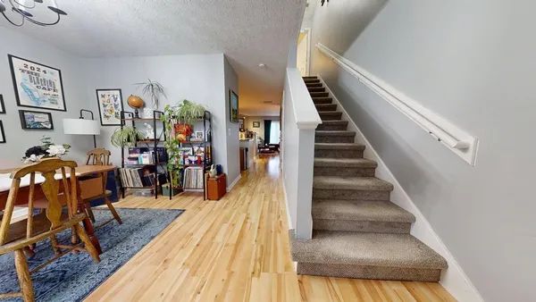 a view of entryway and hall with wooden floor