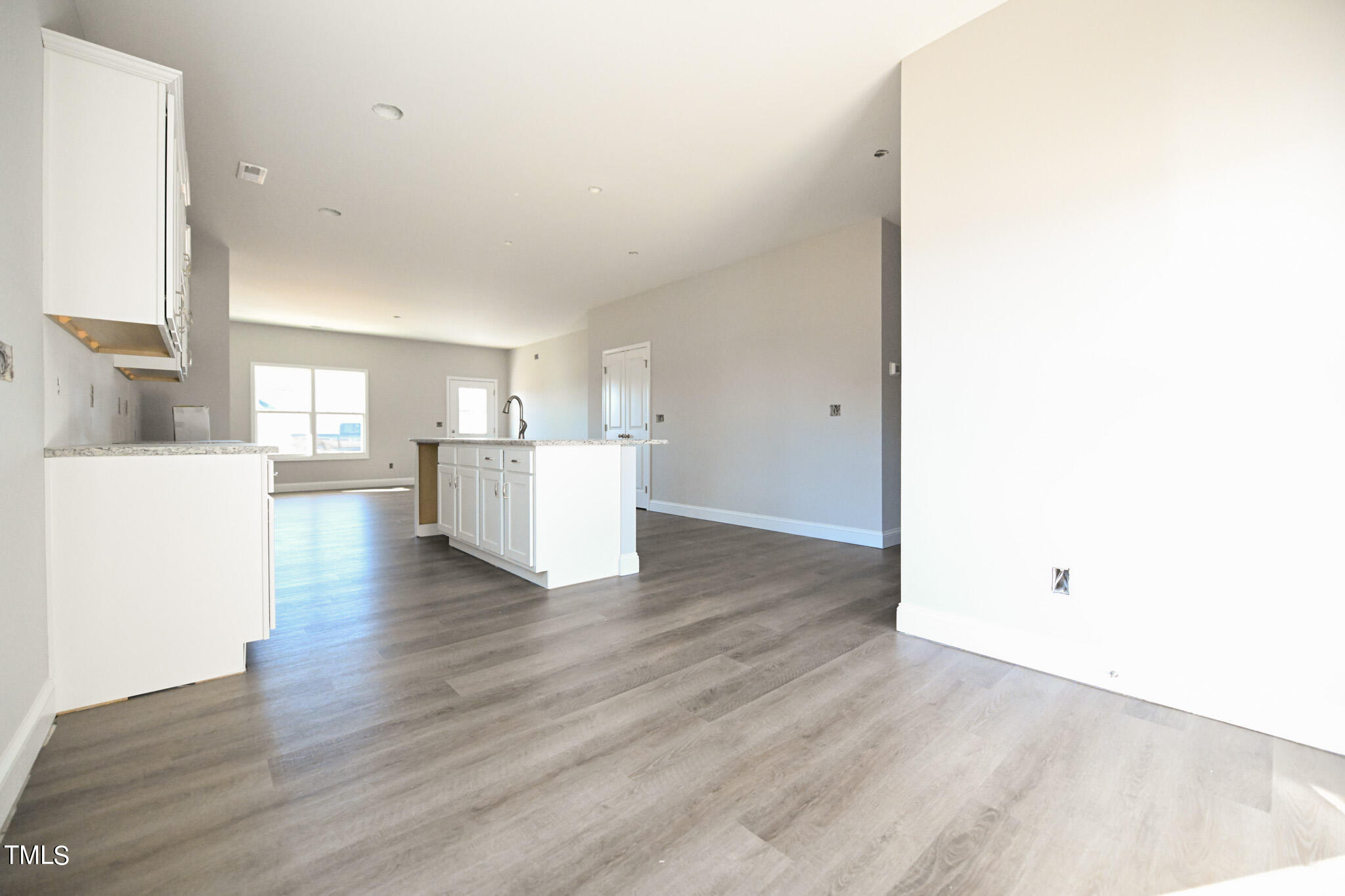 150 Johnson Ridge Way Four Oaks, NC 27524 - Photo 12 of 24 a view of a kitchen with wooden floor and a refrigerator