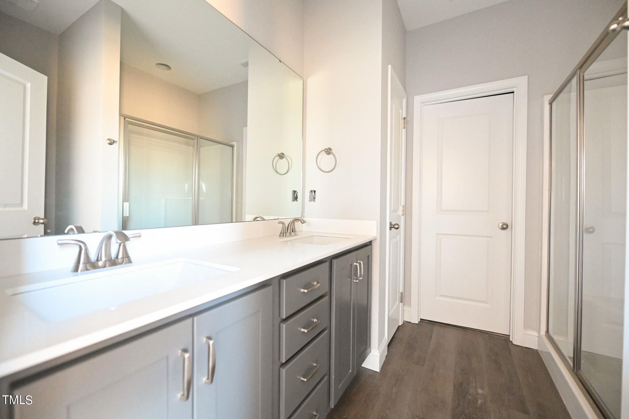150 Johnson Ridge Way Four Oaks, NC 27524 - Photo 16 of 24 a bathroom with a double vanity sink and mirror