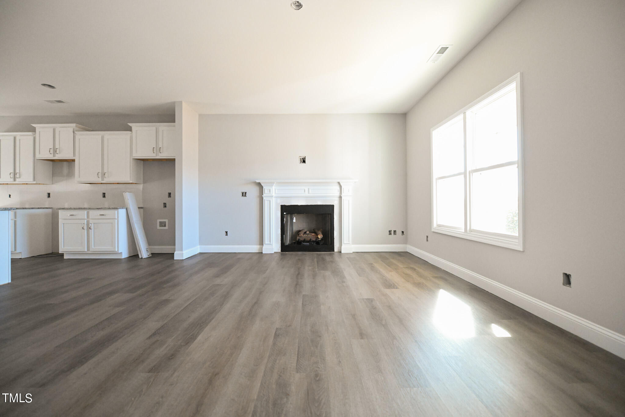 150 Johnson Ridge Way Four Oaks, NC 27524 - Photo 4 of 24 a view of empty room with a fireplace and wooden floor