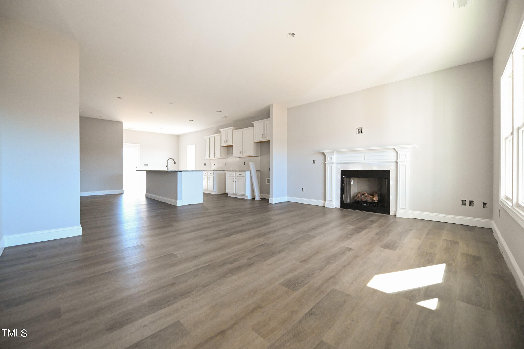 150 Johnson Ridge Way Four Oaks, NC 27524 - Photo 5 of 24 a view of empty room with wooden floor and fireplace