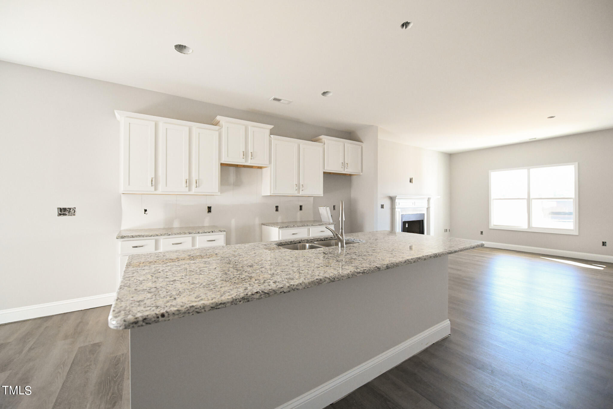 150 Johnson Ridge Way Four Oaks, NC 27524 - Photo 8 of 24 a kitchen with granite countertop white cabinets and a sink