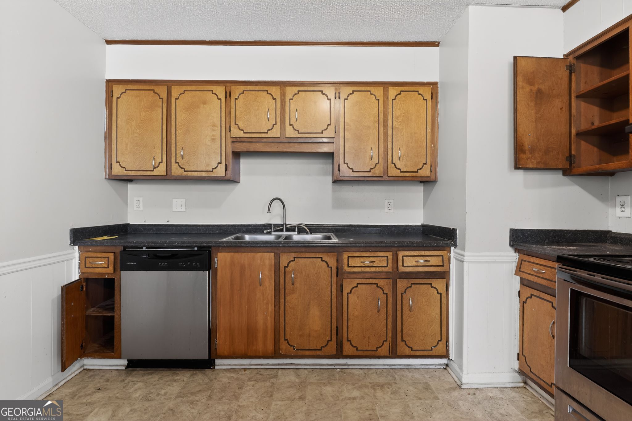 2809 Butler Manor Drive Hephzibah, GA 30815 - Photo 15 of 35 a kitchen with stainless steel appliances granite countertop a stove top oven microwave and cabinets