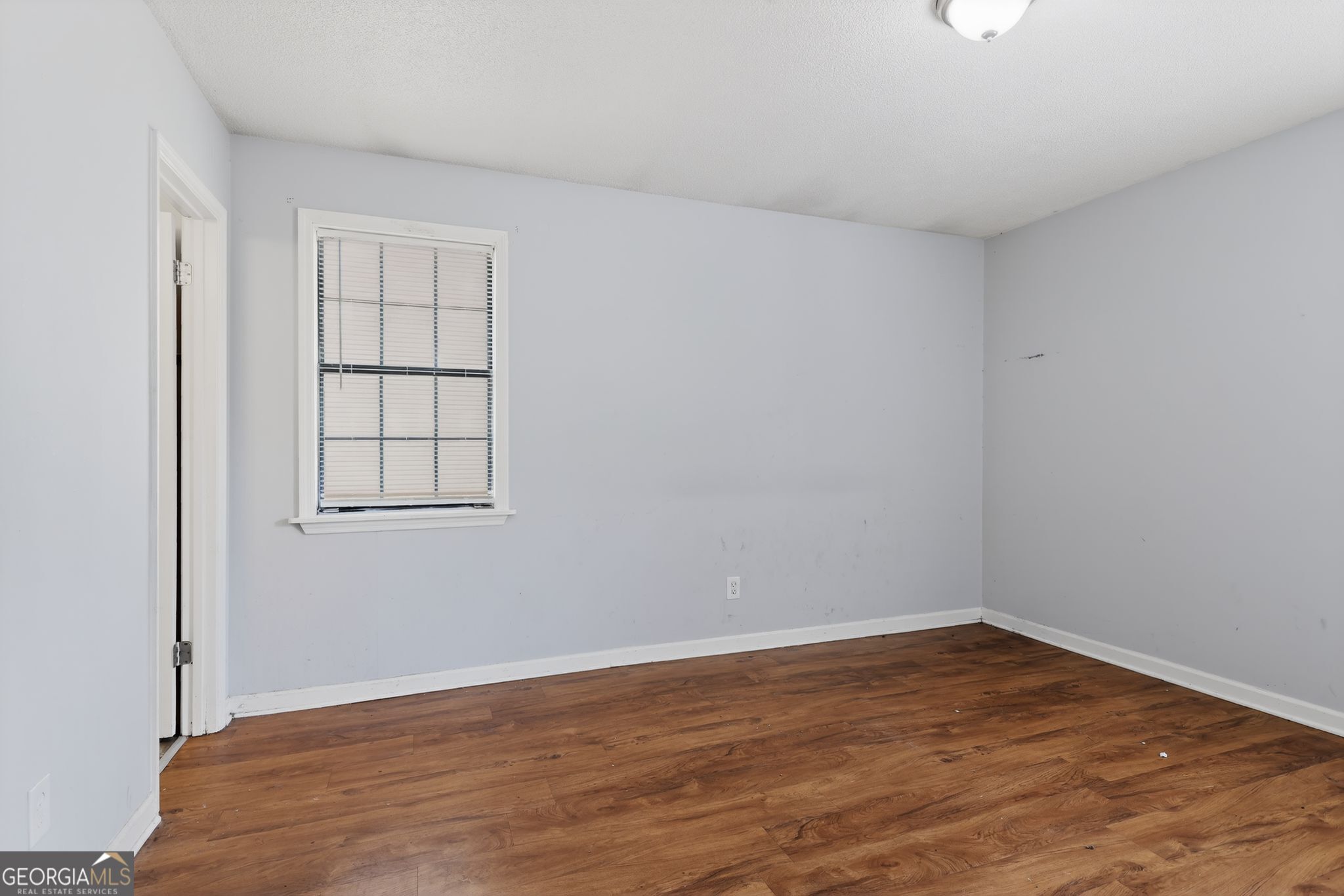 2809 Butler Manor Drive Hephzibah, GA 30815 - Photo 17 of 35 wooden floor in an empty room with a window