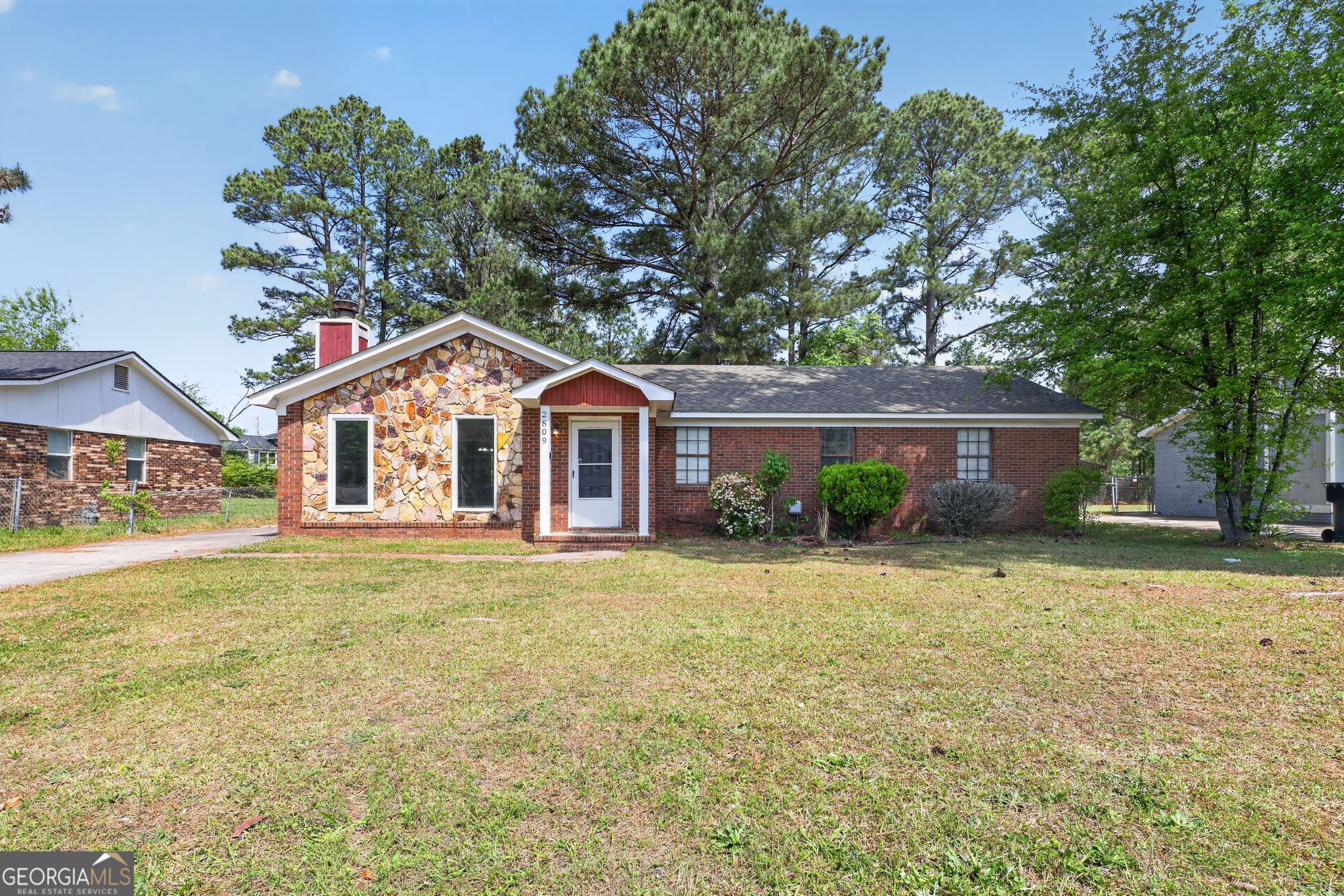 2809 Butler Manor Drive Hephzibah, GA 30815 - Photo 2 of 35 a front view of a house with a yard and garage