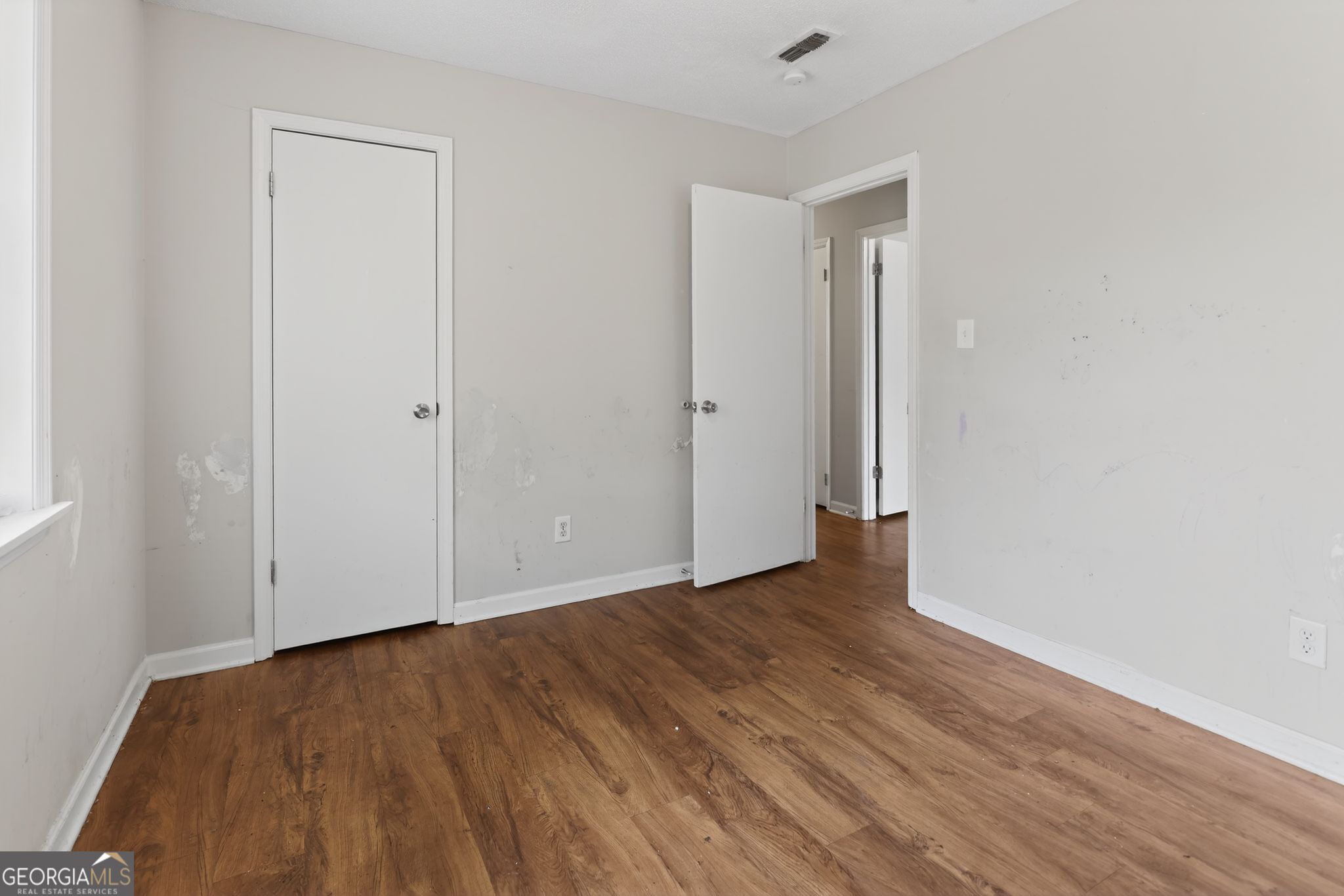2809 Butler Manor Drive Hephzibah, GA 30815 - Photo 23 of 35 a view of an empty room with wooden floor and closet