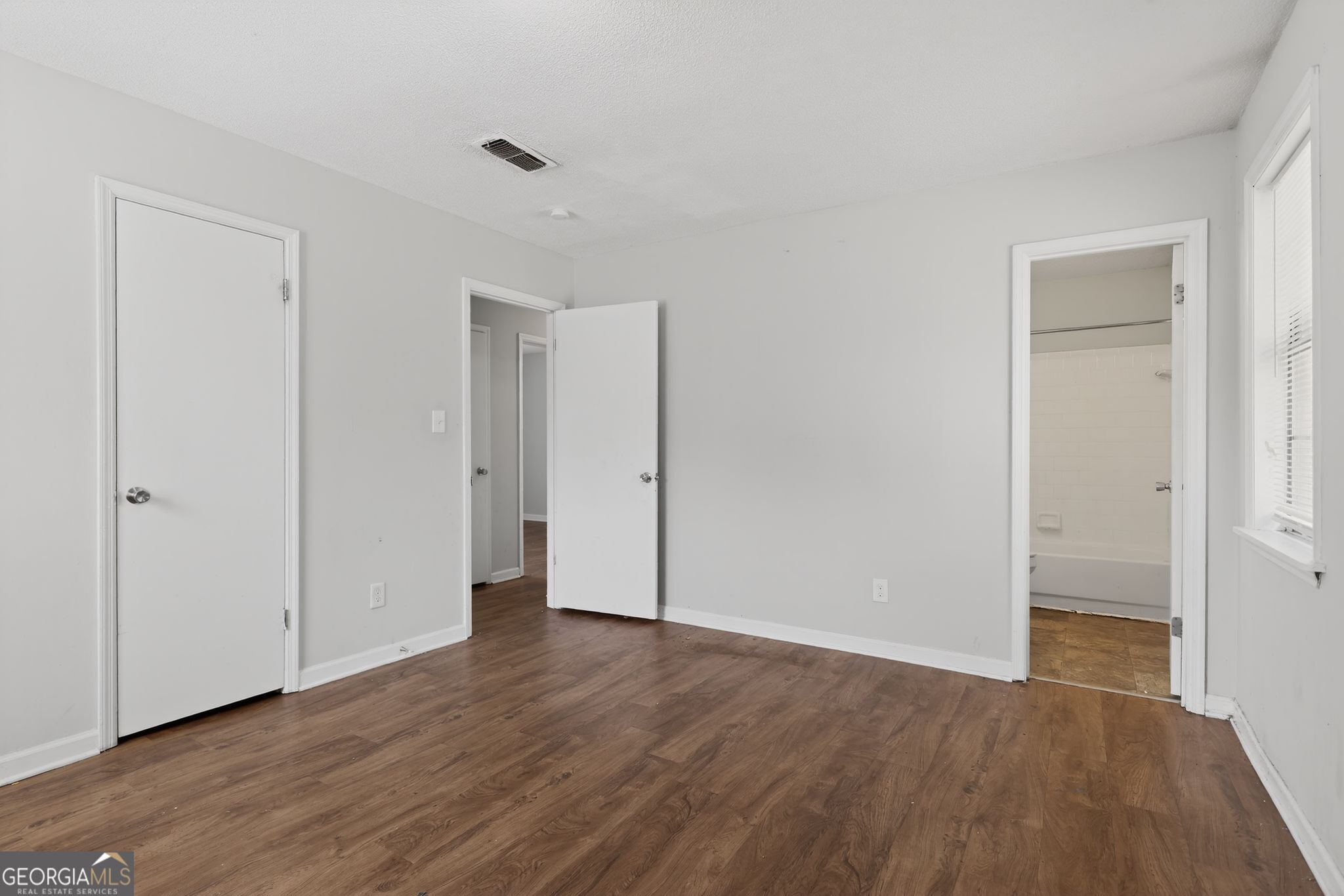 2809 Butler Manor Drive Hephzibah, GA 30815 - Photo 24 of 35 a view of an empty room with wooden floor