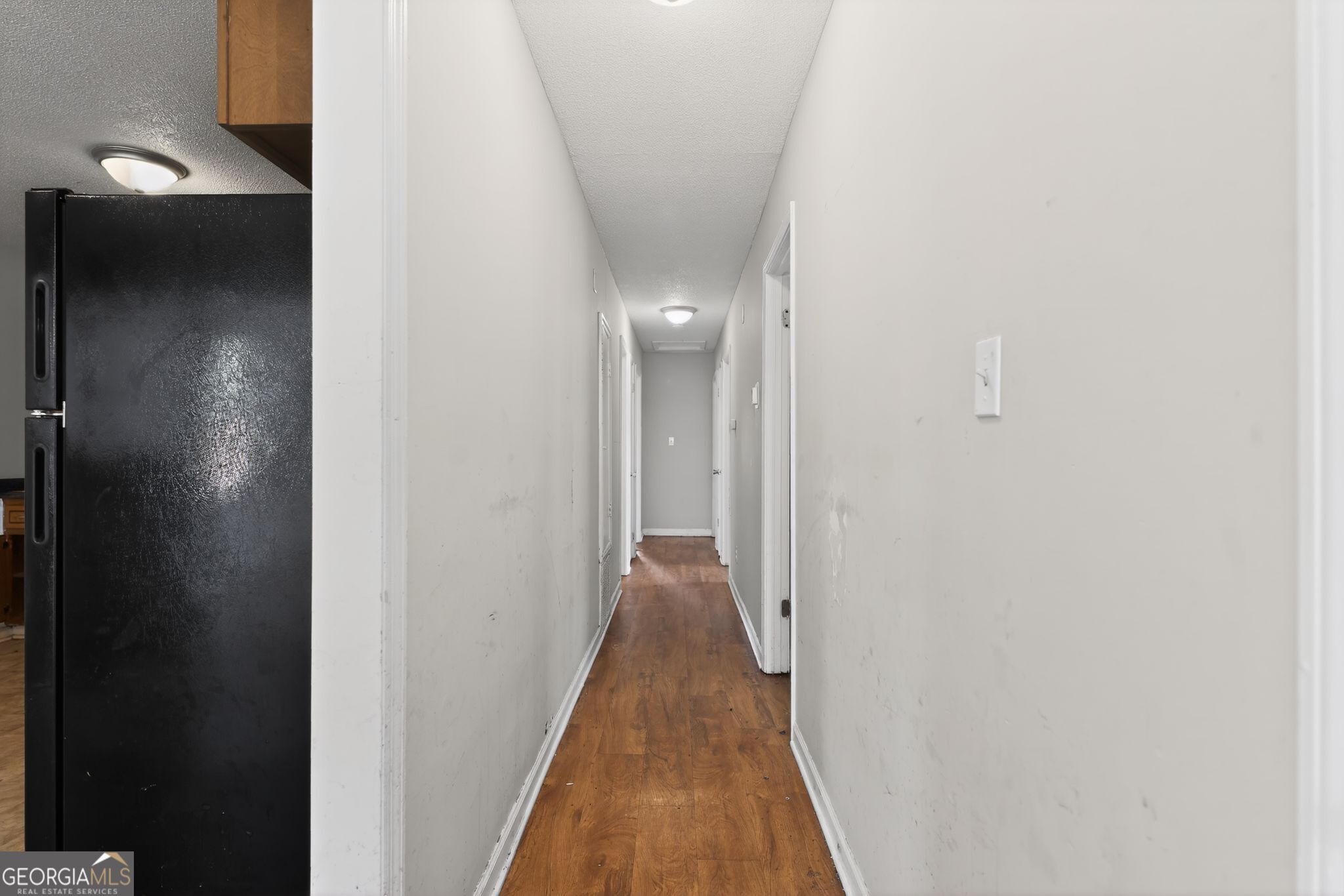 2809 Butler Manor Drive Hephzibah, GA 30815 - Photo 28 of 35 a view of a hallway with wooden floor and staircase
