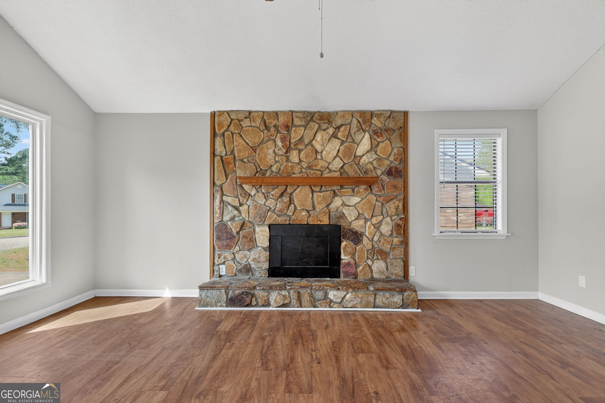 2809 Butler Manor Drive Hephzibah, GA 30815 - Photo 9 of 35 a living room with a fireplace and wooden floor