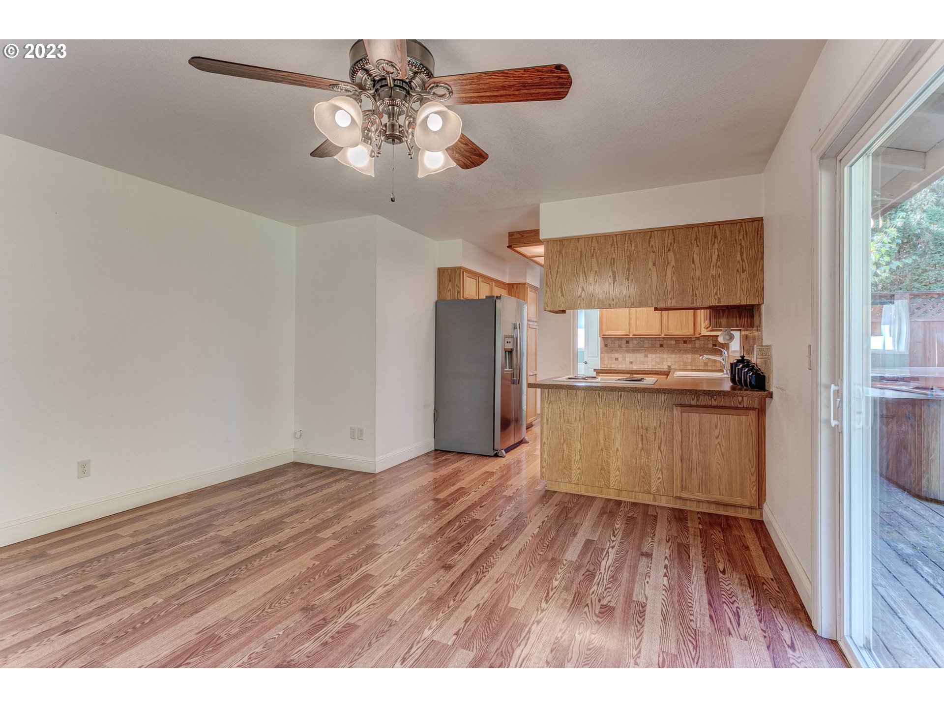 21321 Southeast Alder Street Gresham, OR 97030 - Photo 11 of 39 a kitchen with kitchen island lot of cabinets and refrigerator