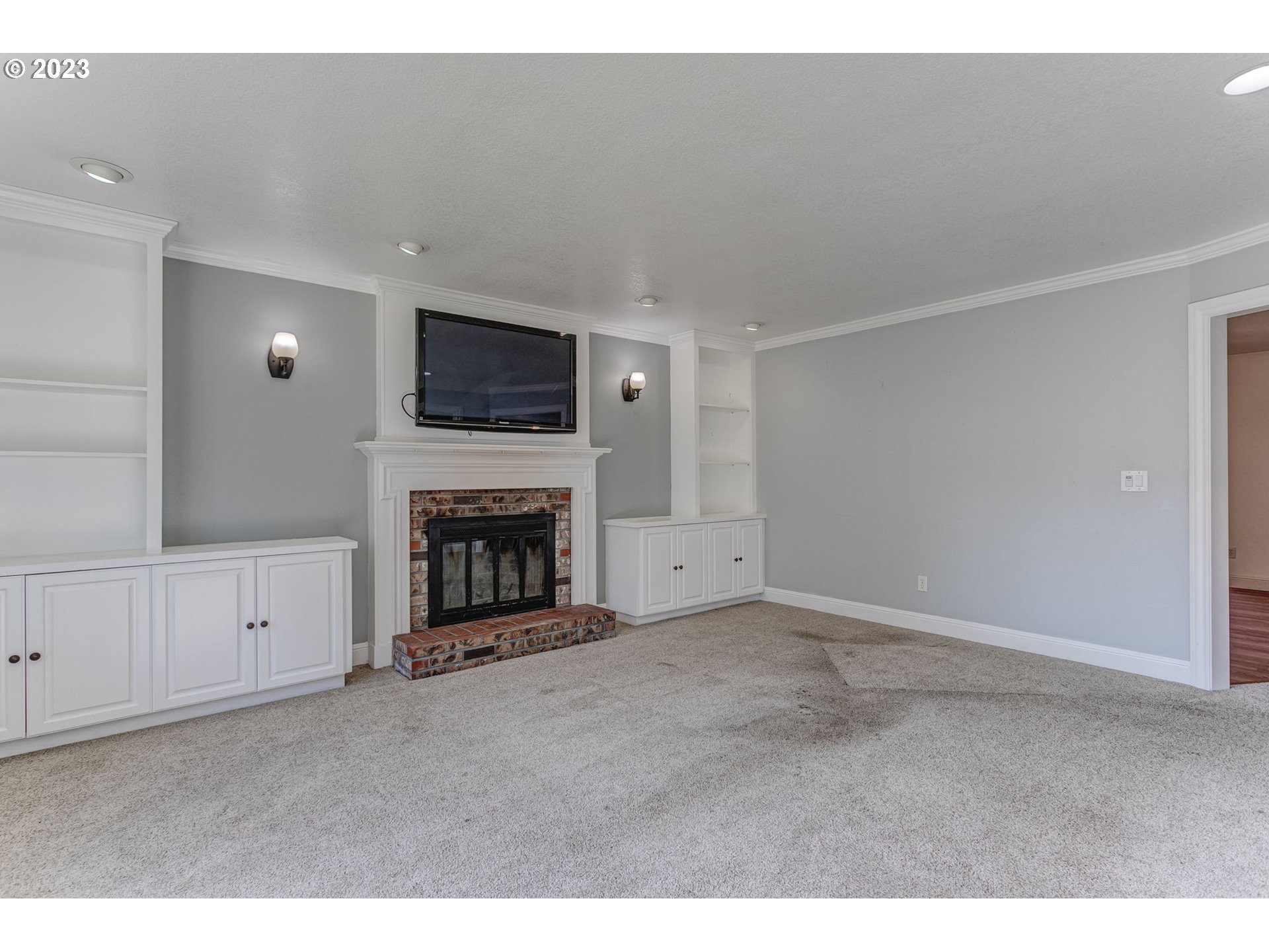 21321 Southeast Alder Street Gresham, OR 97030 - Photo 17 of 39 a living room with furniture a fireplace and a flat screen tv