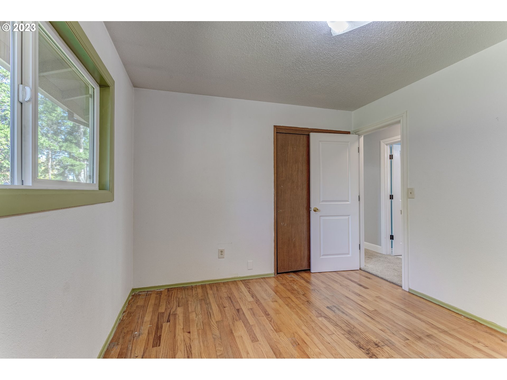 21321 Southeast Alder Street Gresham, OR 97030 - Photo 19 of 39 a view of an empty room with wooden floor and a window