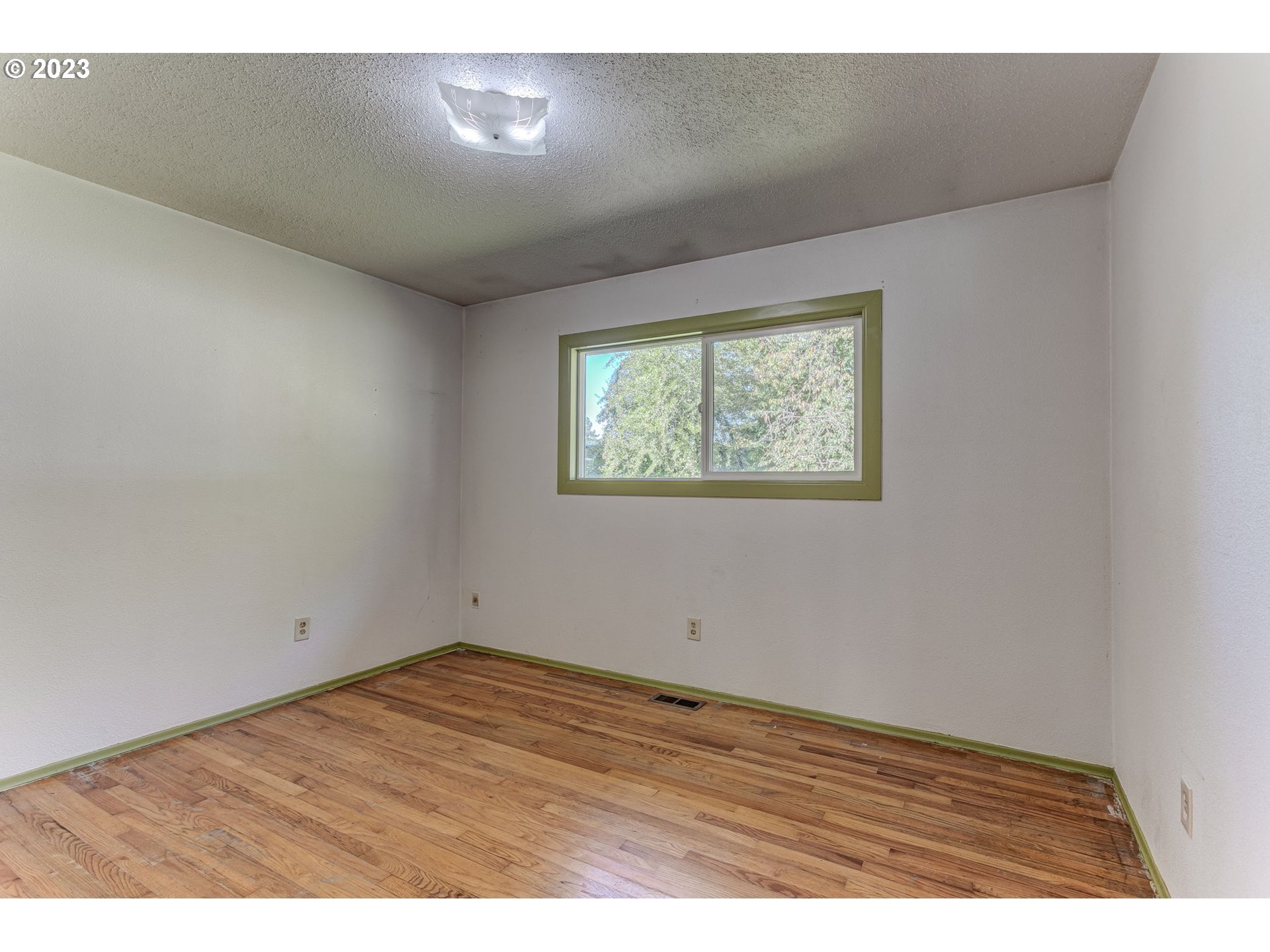 21321 Southeast Alder Street Gresham, OR 97030 - Photo 20 of 39 an empty room with wooden floor and windows