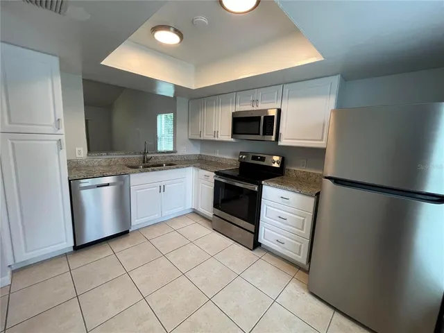 a kitchen with a sink a stove and refrigerator