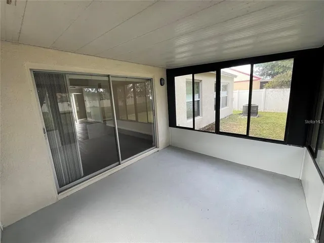 a view of an empty room with glass door