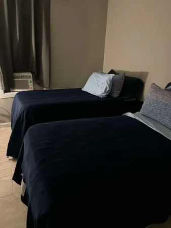 a bedroom with bed and window