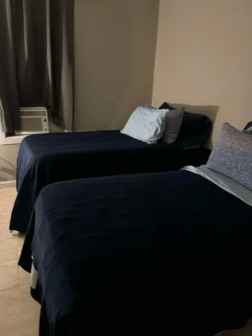 a bedroom with bed and window