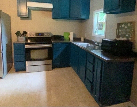 695 Grimes Avenue Silsbee, TX 77656 - Photo 17 of 29 a kitchen with granite countertop a stove top oven sink and cabinets